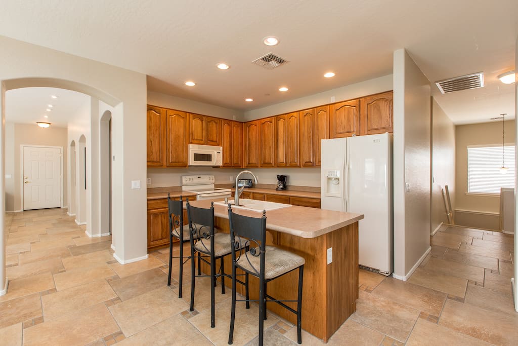 Fully Stocked Kitchen with island sitting stools