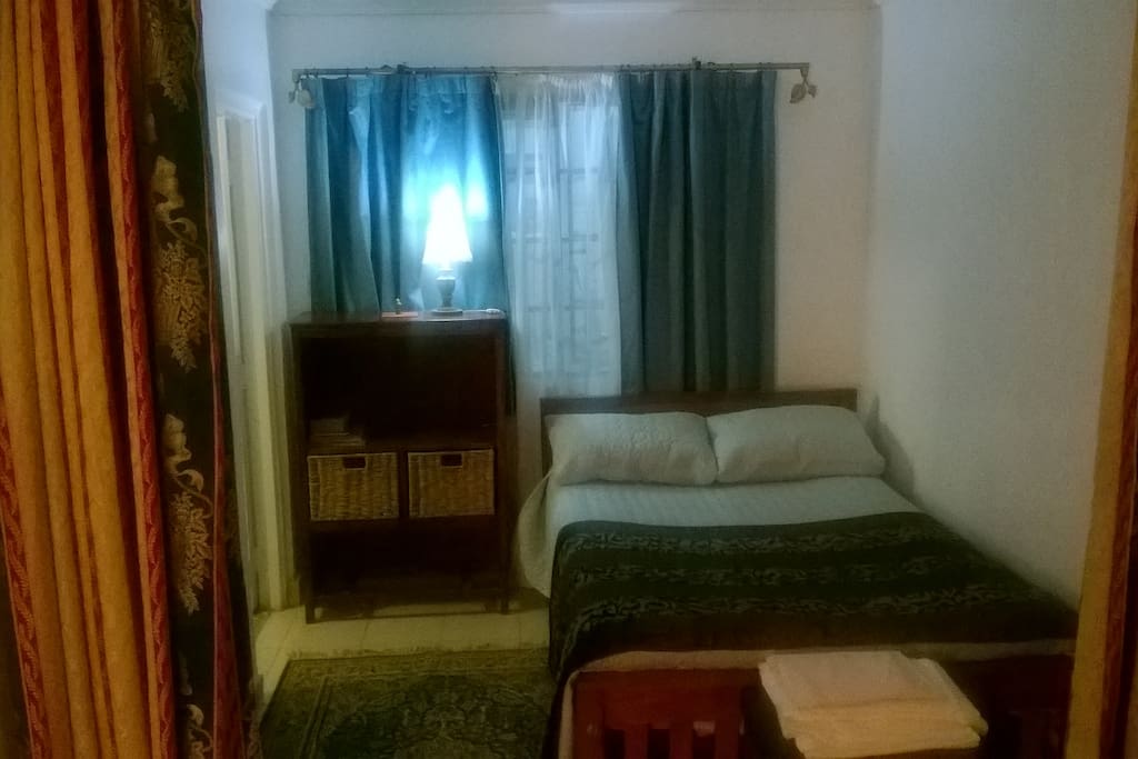 cosy bedroom area with adjacent bathroom.