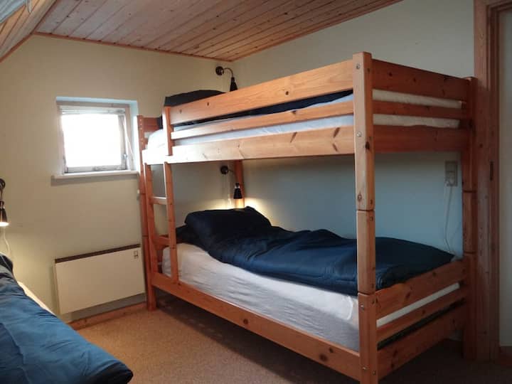 3rd bedroom with one bunk bed, one single bed and a small desk

Located on 1st floor