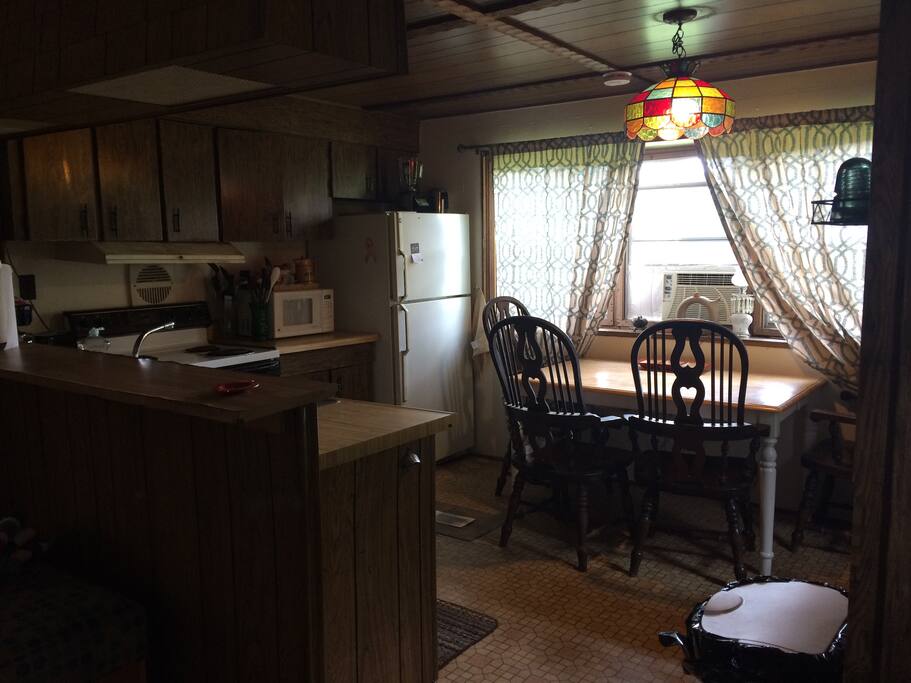 Kitchen area includes oven/ stove, full size refrigerator, microwave, coffee pot, and toaster.