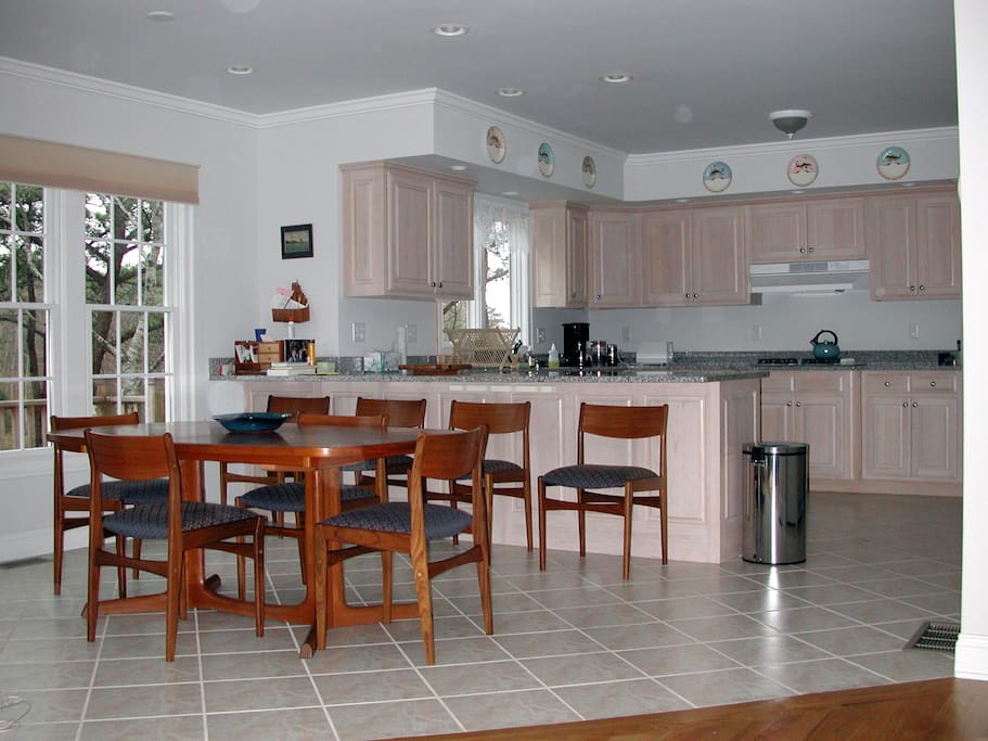 Well-stocked gourmet kitchen and dining area with expandable table