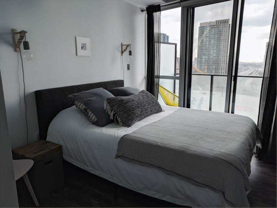 master bedroom with private balcony + endless natural light (note: blackout blinds are available)