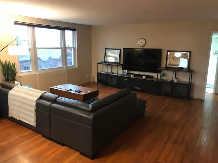 Spacious living room with comfortable New leather furniture, 65" 4K  SmartTV, game consoles, surround sound and premium Cable/Tivo/DVR features.