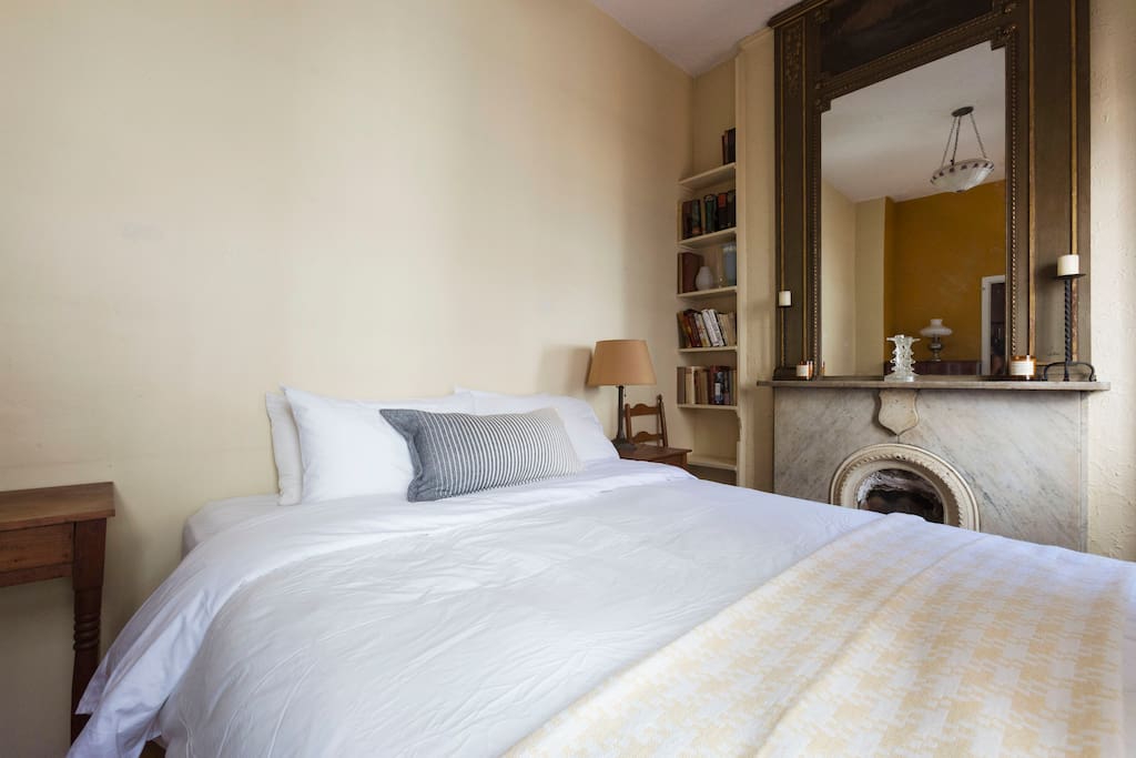 Stay cozy by the marble fireplace in your bedroom