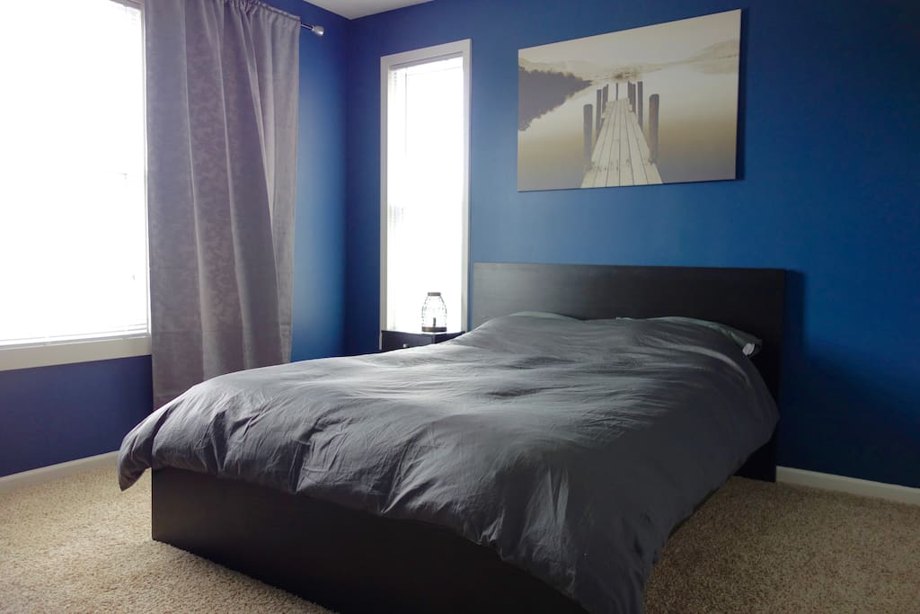 Comfortable queen size bed with views towards the Mississippi River