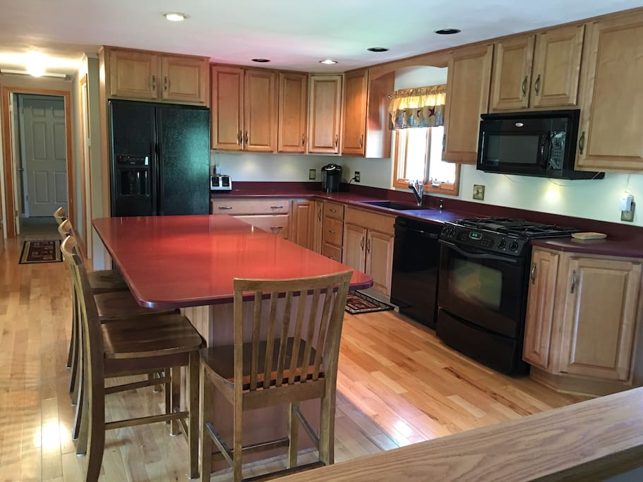 Full Kitchen, Gas cooktop, Microwave, Dishwasher, Corian Counter Tops, Cherry Wood Mode Cabinets