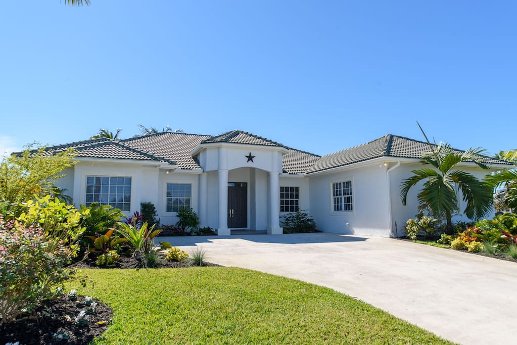 Front of house with large driveway for parking of up to 3 cars.