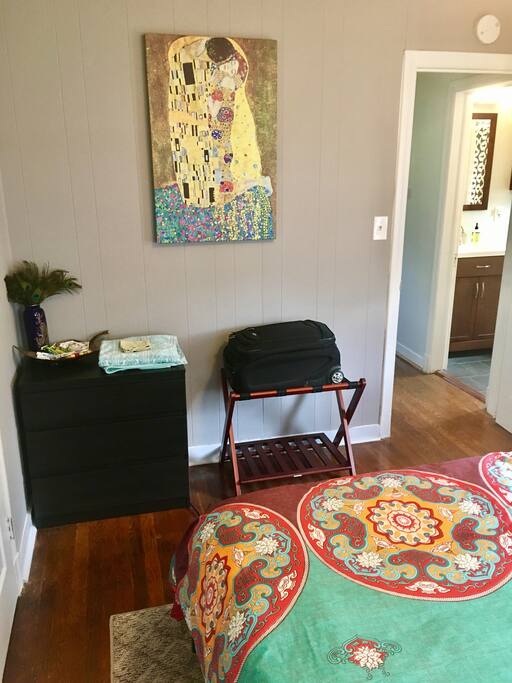 Guest Bedroom with Dresser, Luggage Rack, and Bathroom in Right Corner