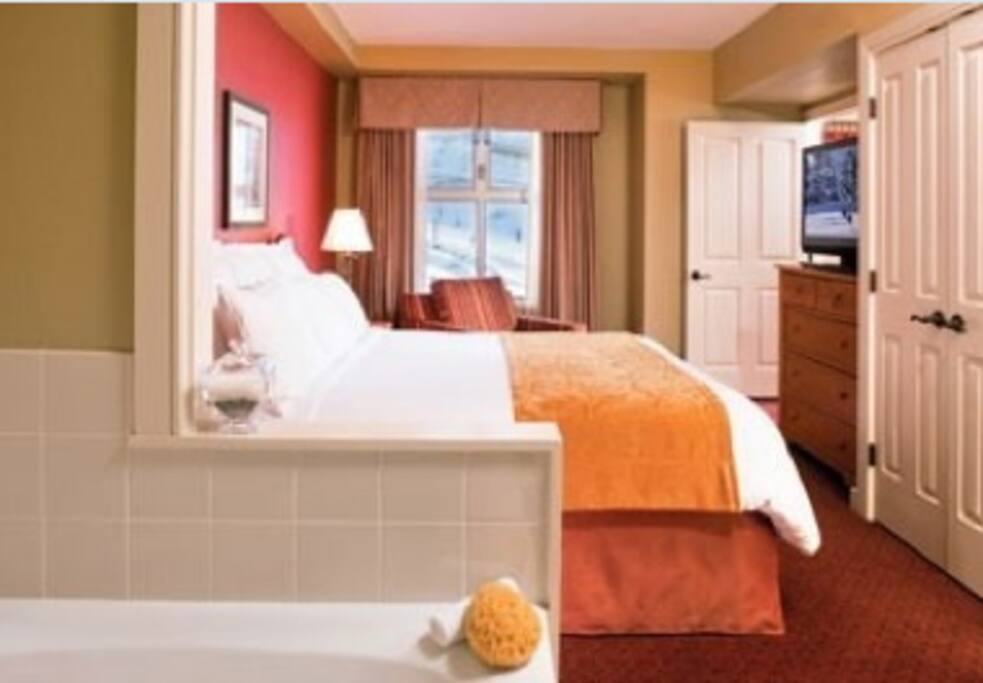 This is the master bedroom, King bed, jacuzzi tub, safe, TV