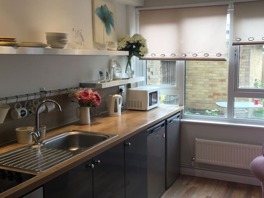 Modern styled kitchen. Includes microwave, kettle, fridge and freezer.