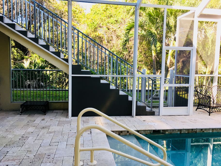 Outdoor stair case leading to private second floor balcony and guest house entrance.