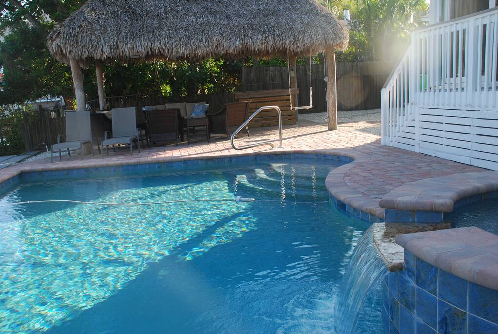 Beautiful pool and hot tub along side tiki hut and canal.