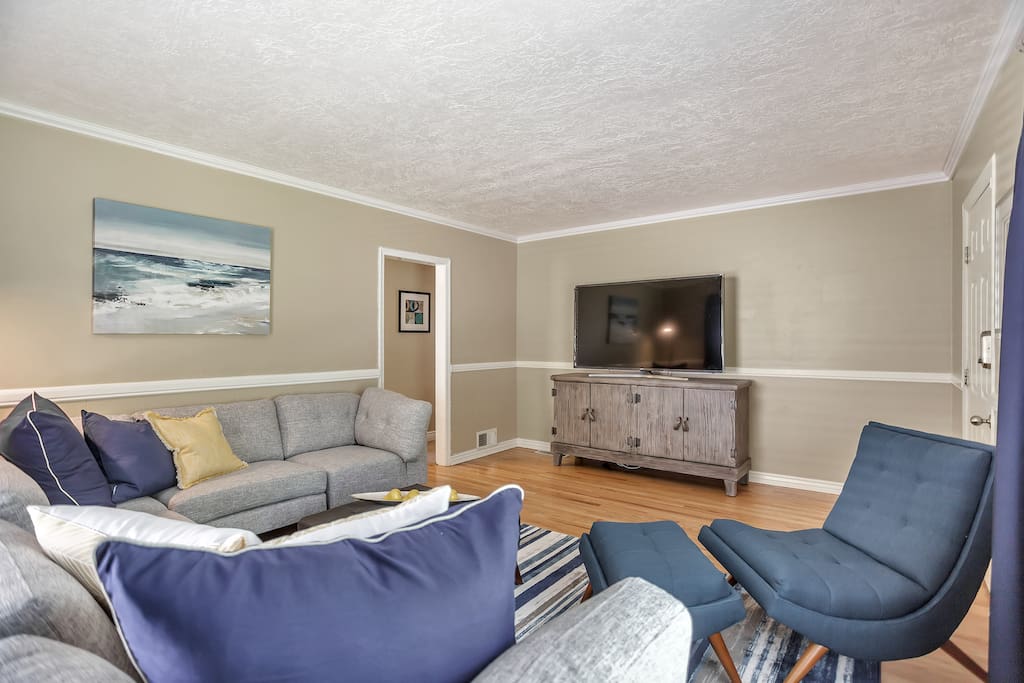 Bright and spacious living room, hardwood floors, 65 inch flat screen smart TV with Netflix