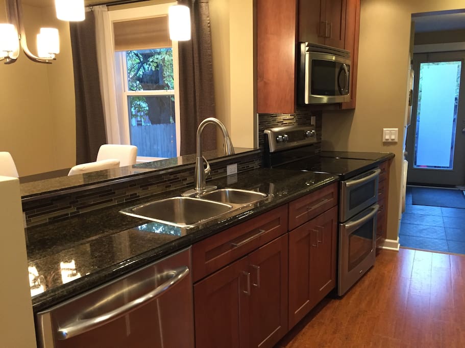 Updated kitchen with stainless appliances and granite counter tops.