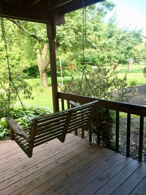 Private deck with swing overlooking woods and lake.