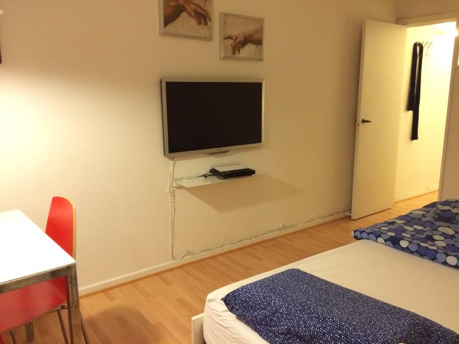 The room with TV and HDMI cabel and a converter for Mac to plug the computer to the TV
