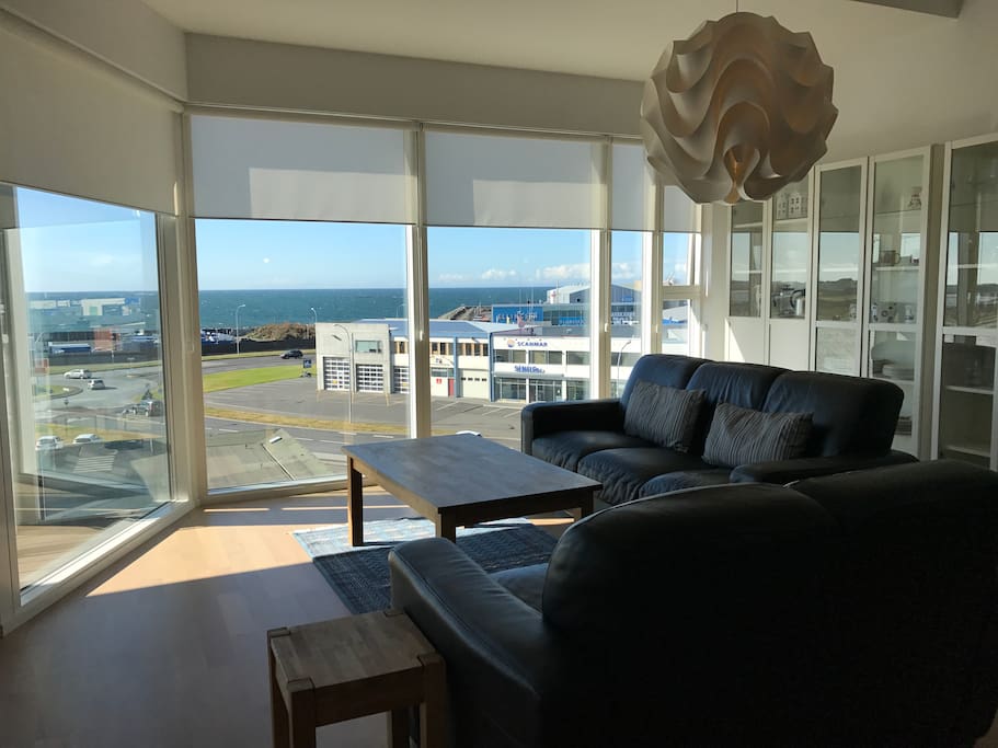 Living room with scenic ocean view during the day
