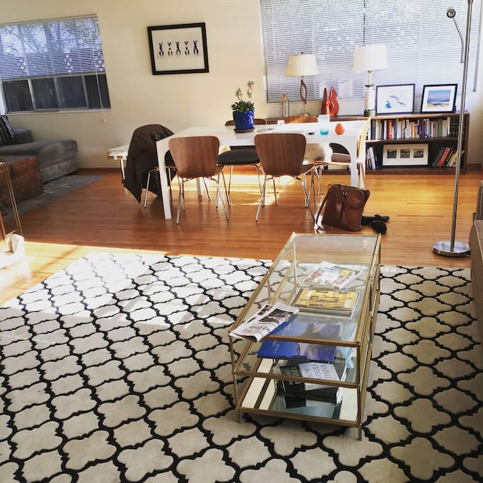Full living space, with two couch areas, a TV and a dining room table