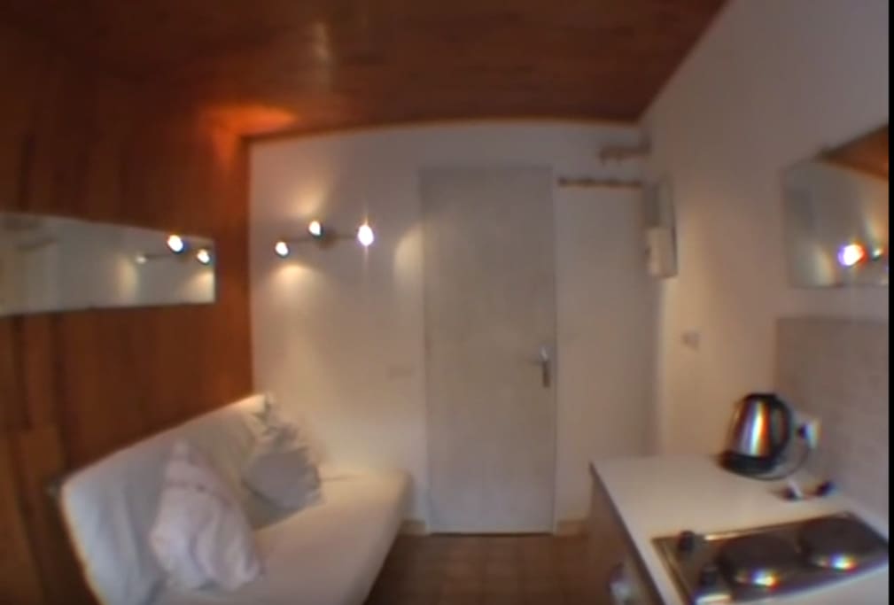 Sofa bed, hobs and front door.