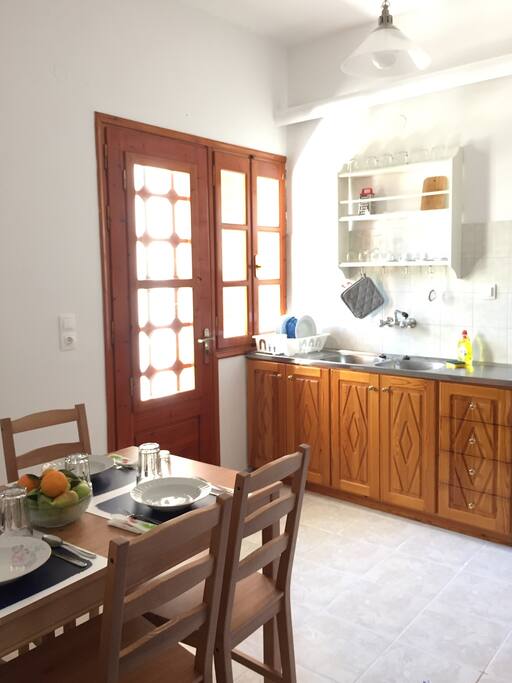 Kitchen with dinner table and the shared balcony's door, which comes with a key