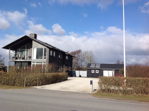 Fjord villa by child and surf friendly beach.