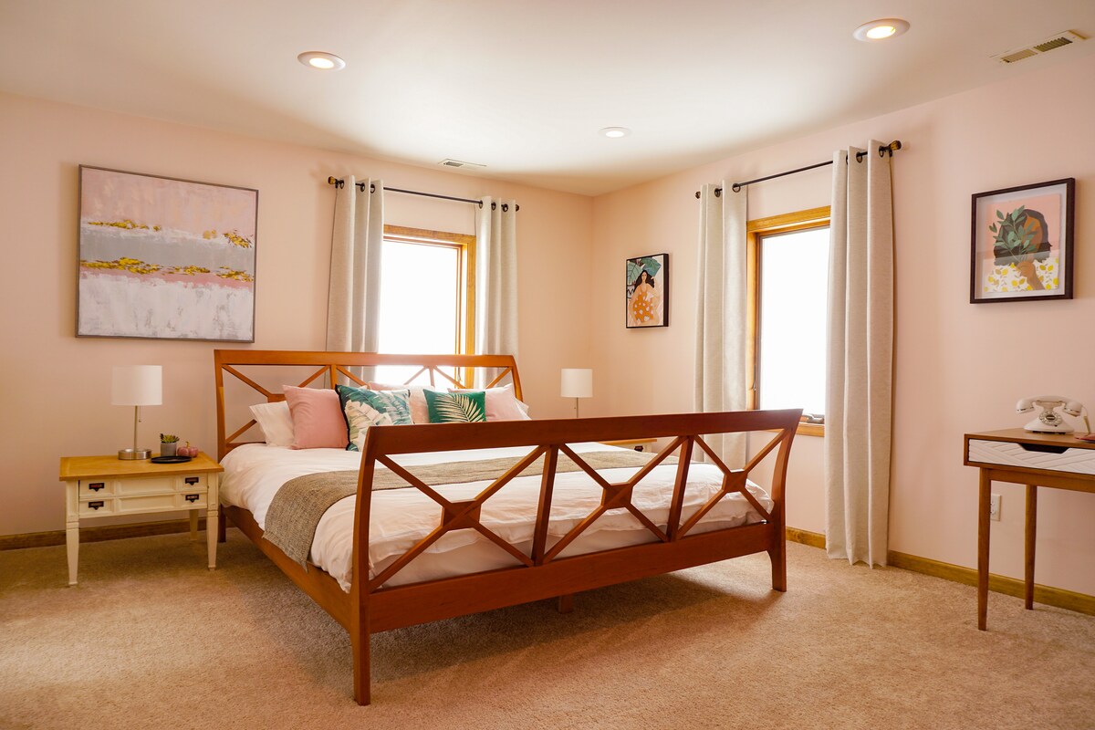 Our first bedroom is spacious and has a king bed, full-length mirror, desk, en suite bathroom with jacuzzi tub, and 32" TV.