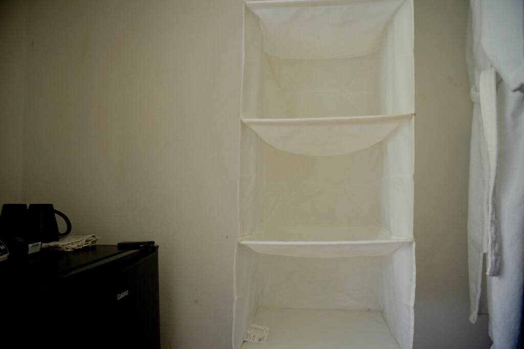 Closet with mini fridge and coffee maker