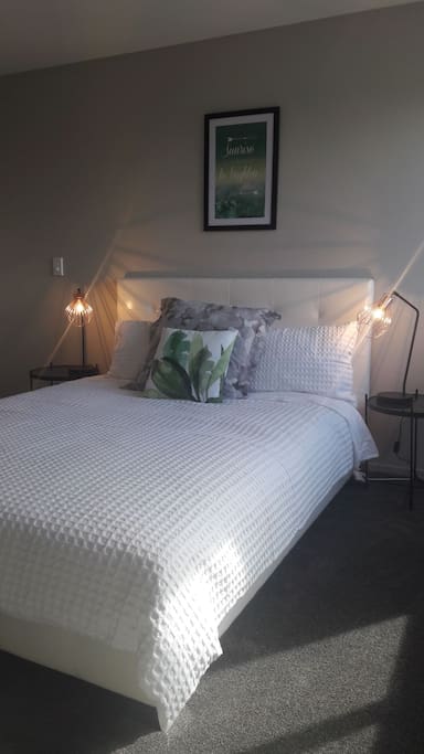 Sunny, spacious bedroom with very comfortable bed and modern furnishings