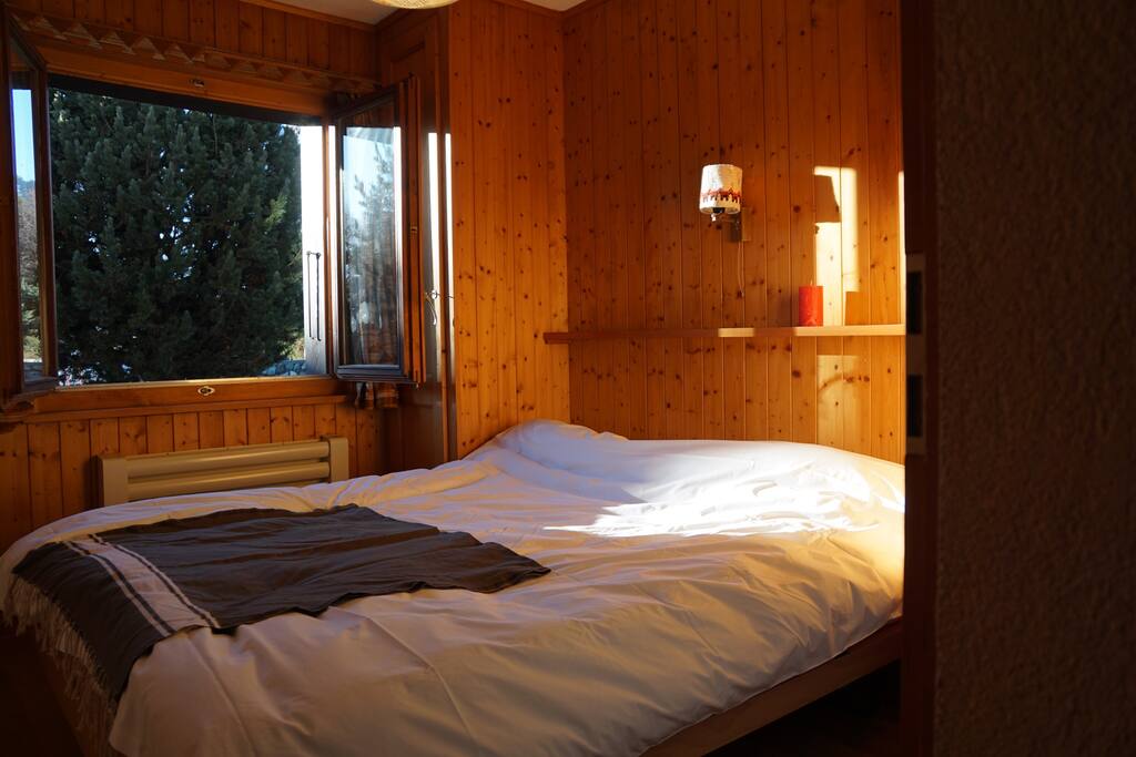 Bright double bedroom with fitted wardrobes. Windows open into the garden