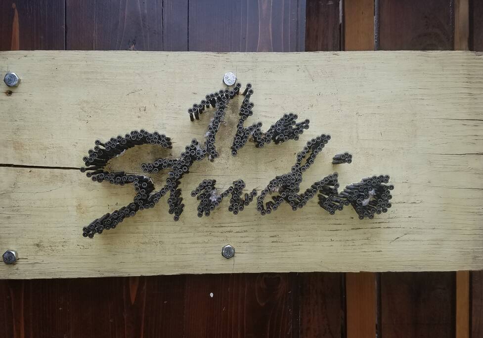 An artist friend of mine made this sign for the Studio. Can you tell what he used to form the words "The Studio?" (Some of his other outdoor works are on display around the property.)