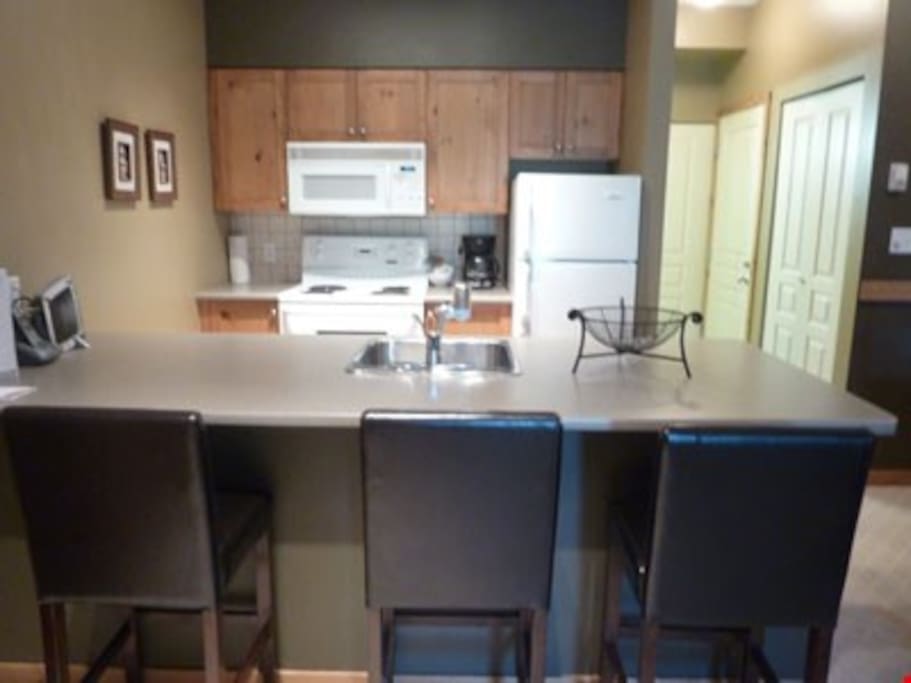 The full kitchen allows guests to prepare meals in the privacy of their own suite. They can enjoy them together at the breakfast bar, complete with stools.