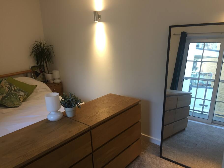 Master bedroom (full-length mirror revealing private balcony off bedroom)