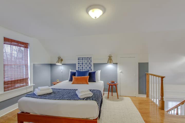 Spacious bedroom with seating area and natural light