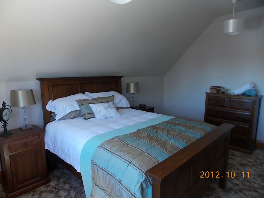 queen size bed in an upstairs room.