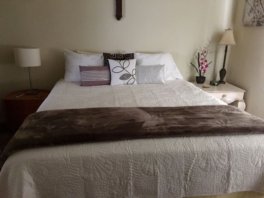 Bedroom with Cal King size bed, private bathroom and Armoire.