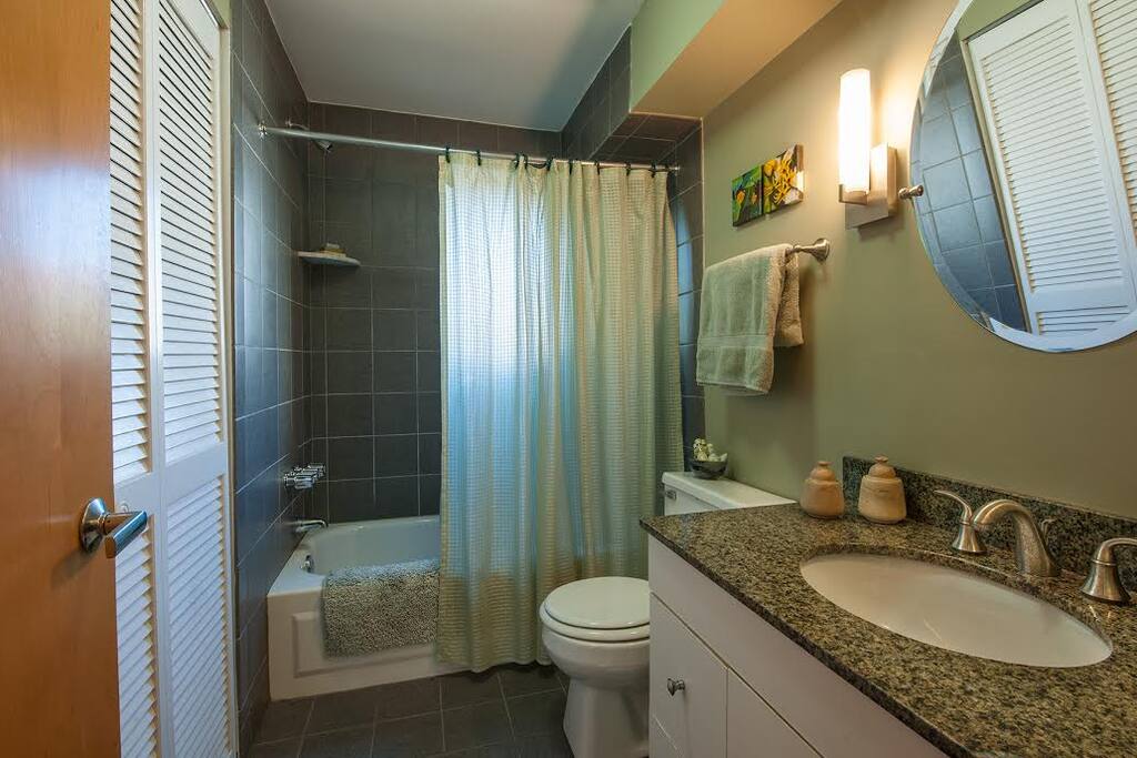 Bathroom with many towels, a view of Magic Gardens and a washer and dryer.