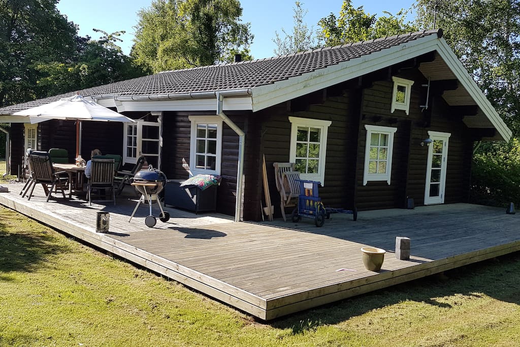 Big wooden terrace. House seen from garden side.