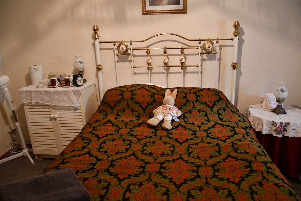 Room 1 has a queen bed, 3 chairs, a small table, dressing table, wardrobe and tea/coffee making area and a T.V.