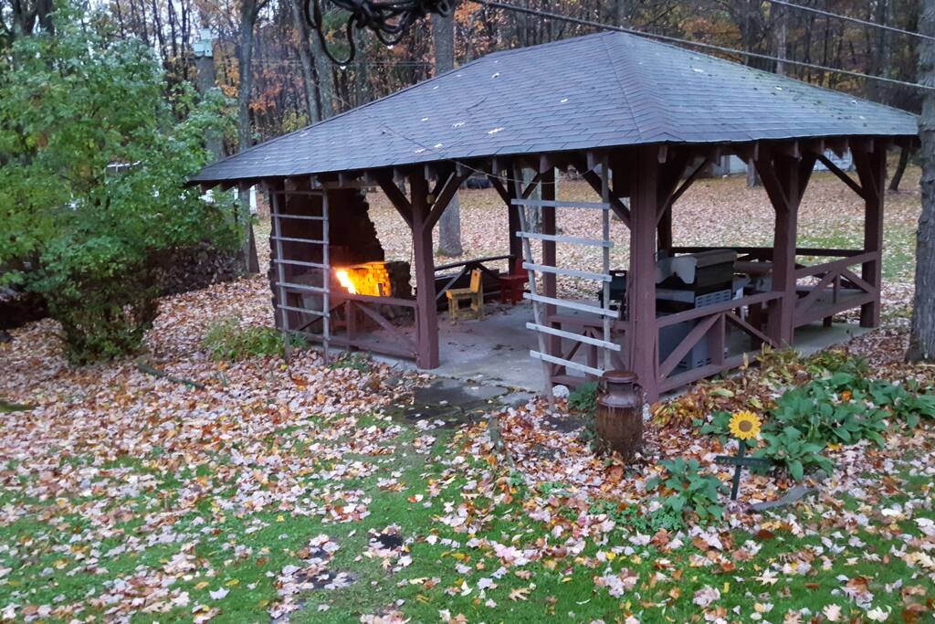 Gazebo features an outdoor fireplace, gas grill and seating.