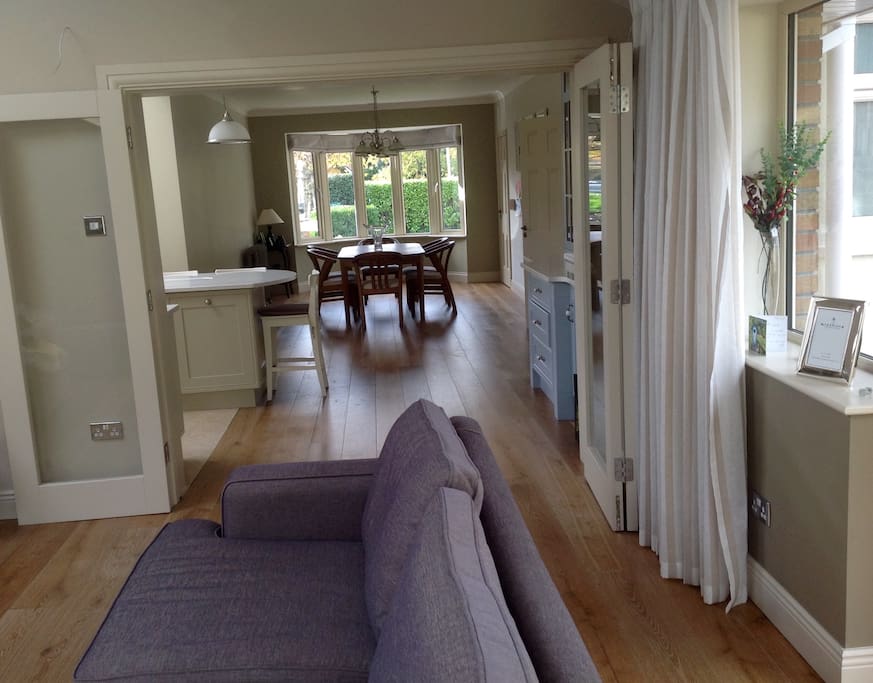 The family room is connected to the kitchen by glass bifold doors.