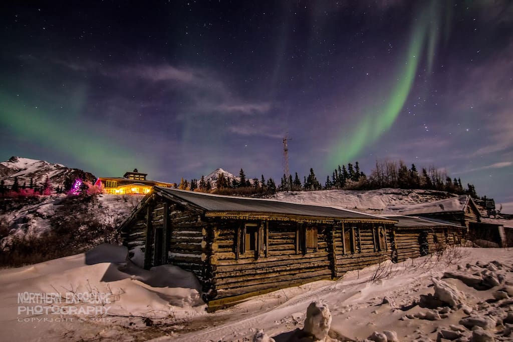 Northern Lights with the lodge and 100 year old roadhouse in the foreground.