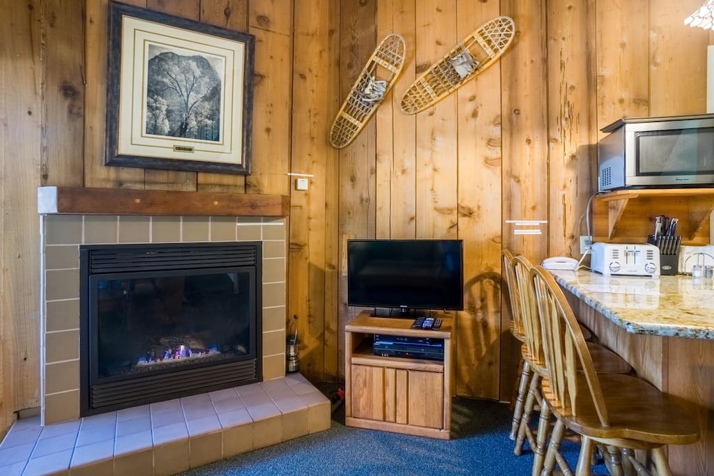Living room has a gas fireplace, TV & DVD player.
