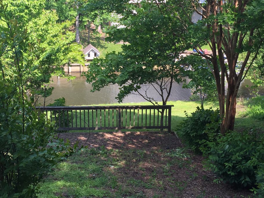 View from screened in deck of lake and dock.