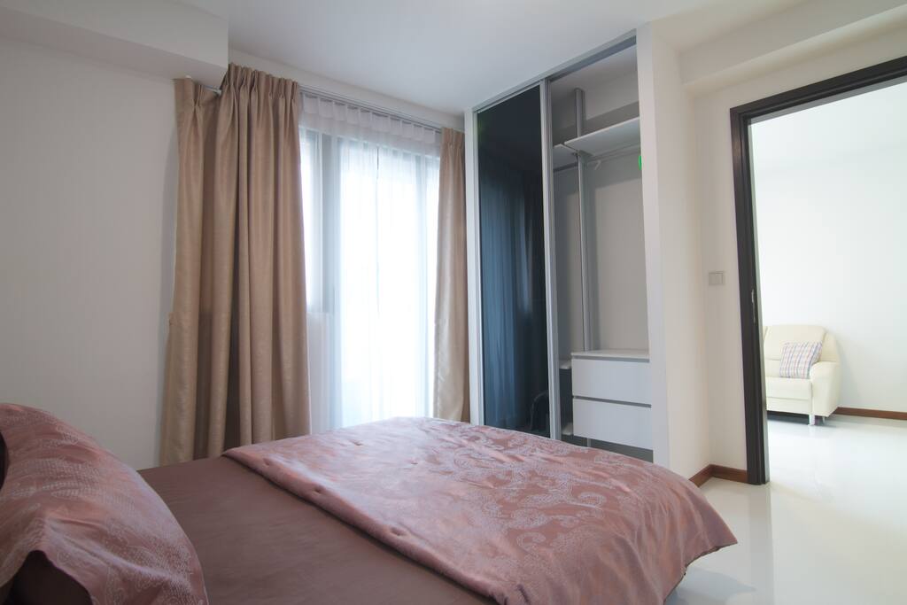 Bedroom with queen-sized bed and built-in wardrobe