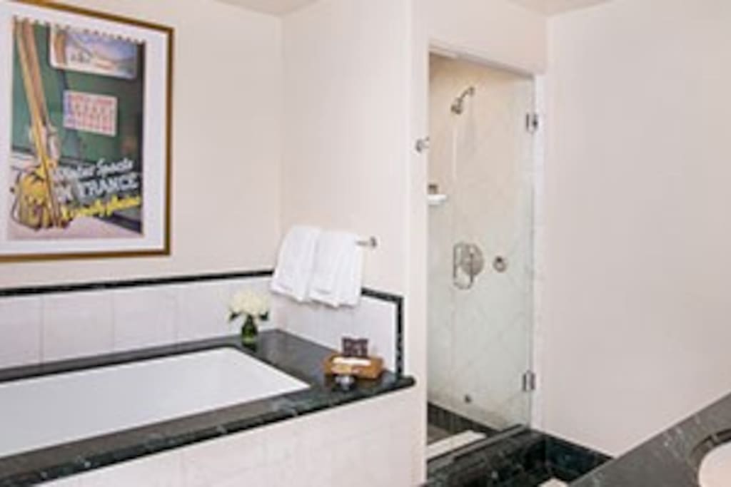 Pamper yourself in the 5-piece marble bathroom, complete with TV and plush bathrobes.