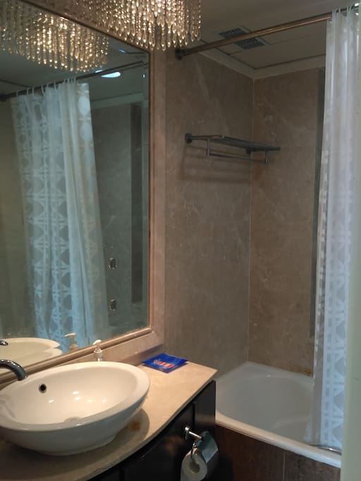 Bathroom with bathtub, heater