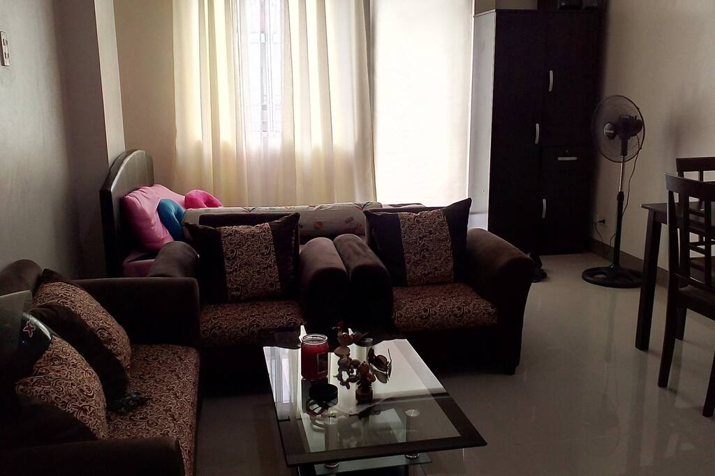 Queen Size Bed beside the 2-1-1 Sofa with Glass Center Table and 4 seater Dining Table