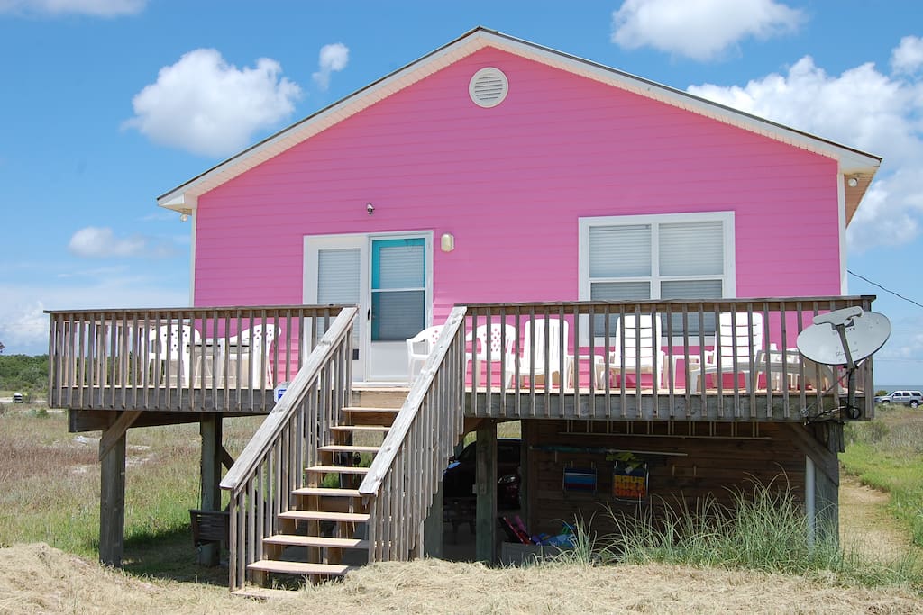 Back of house has deck and lounge chairs for sunning
