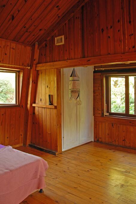 The inland facing room is surrounded by greenery of the lush garden.