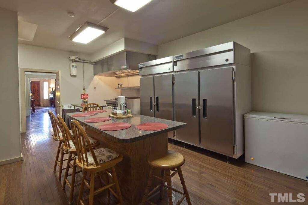 Commercial sized kitchen has gas stove with large double ovens, 6 burners, griddle top and broiler. The refrigerator can hold lots of your food for your stay and the chest freezer is ideal to keep bags of ice for your coolers.